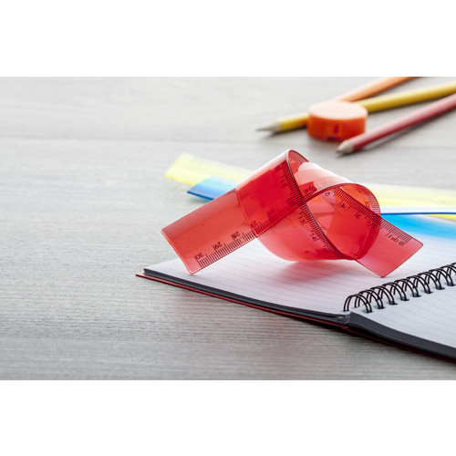 Righello in plastica rossa sopra scrivania