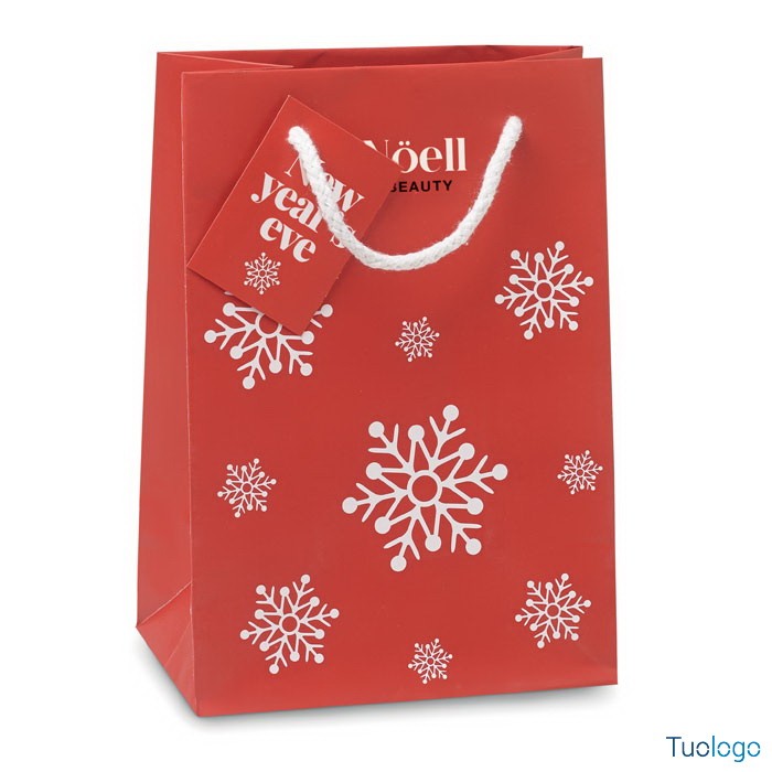 Shopper rossa con fiocchi di neve bianchi stampati sopra e cartellino rosso con logo