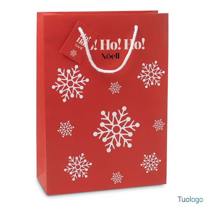 Shopper rossa con fiocchi di neve bianchi stampati sopra e cartellino rosso con logo